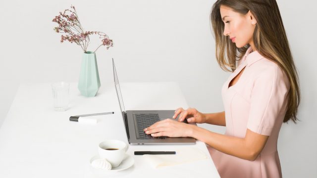 girl browsing laptop at desk