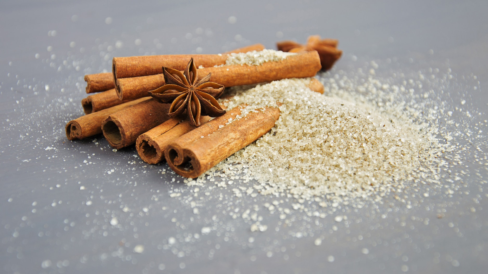 close up cinnamon sticks sugar