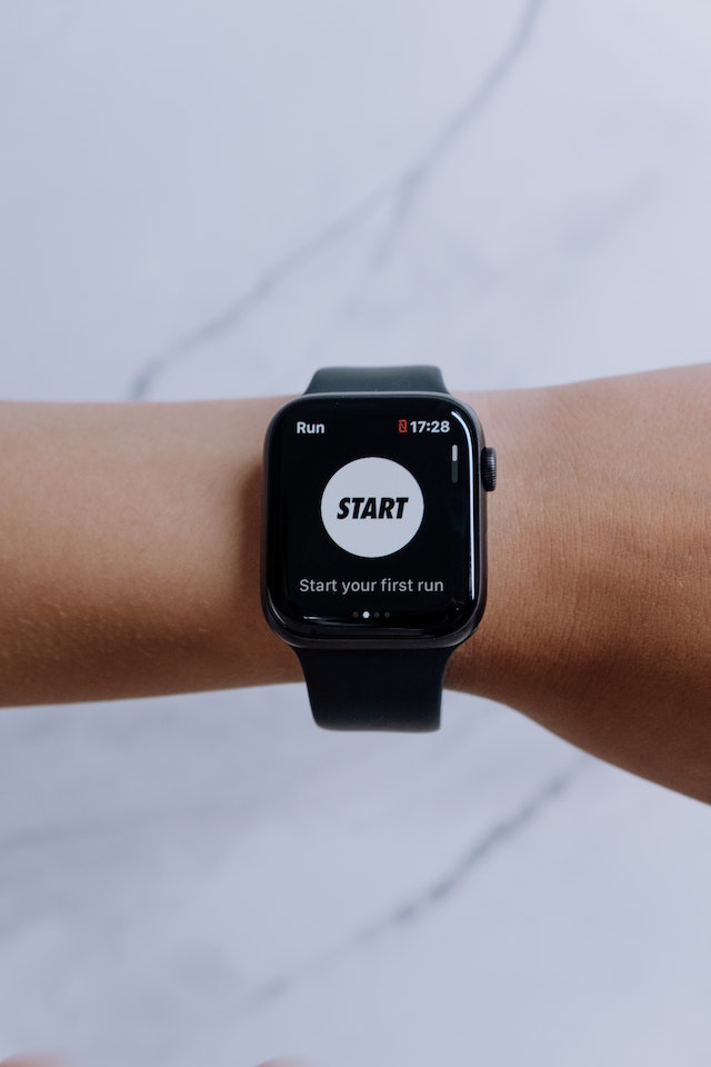 A black smartwatch with a display saying "Start your first run"